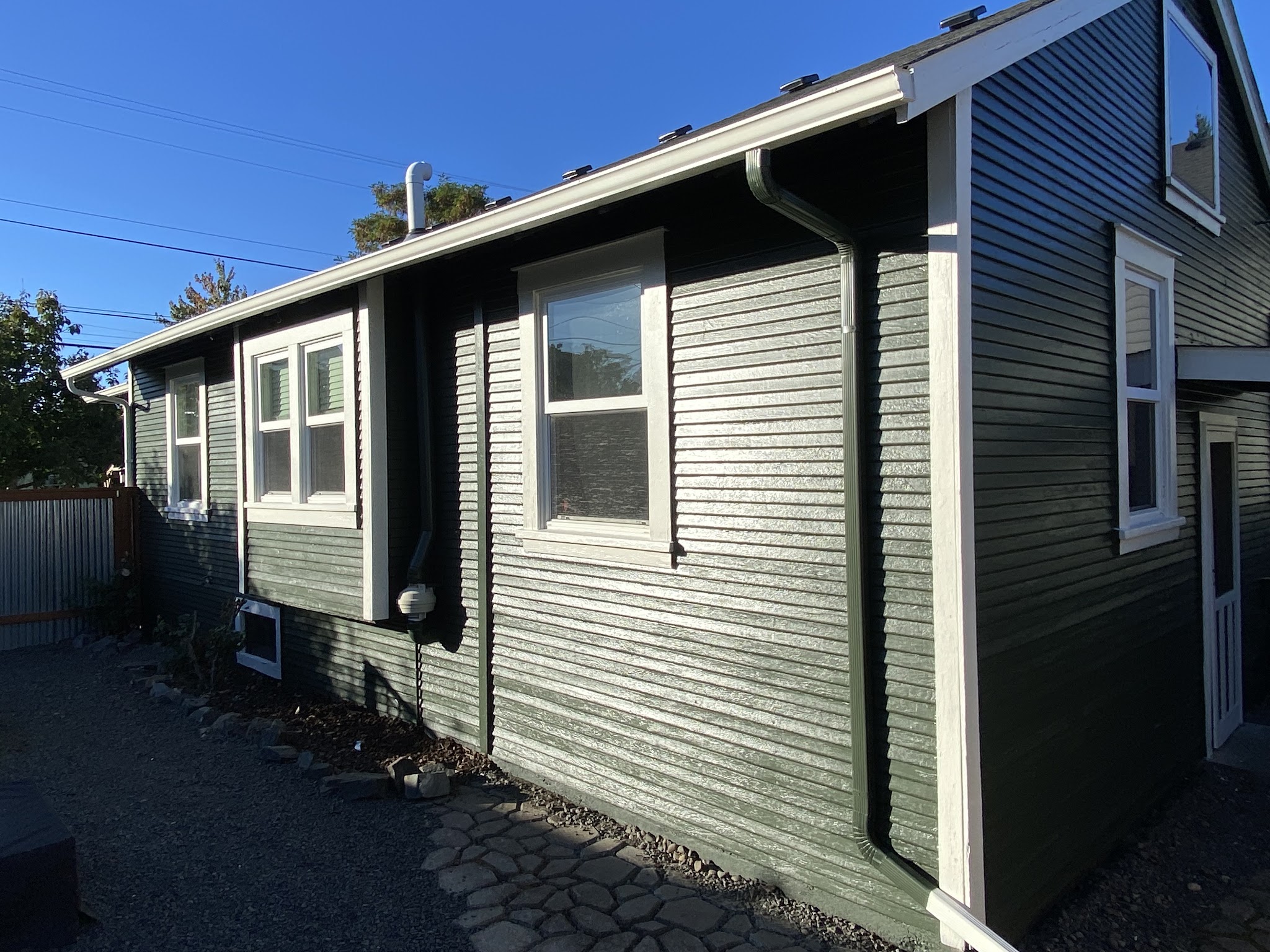Completed exterior repaint with olive-green siding